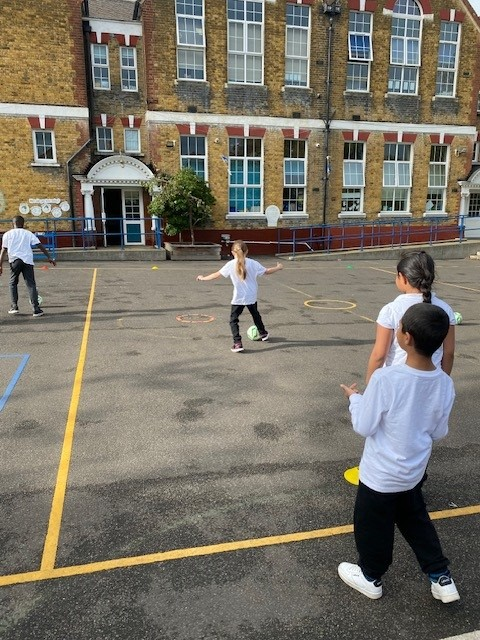 Practicing dribbling a football in P.E.