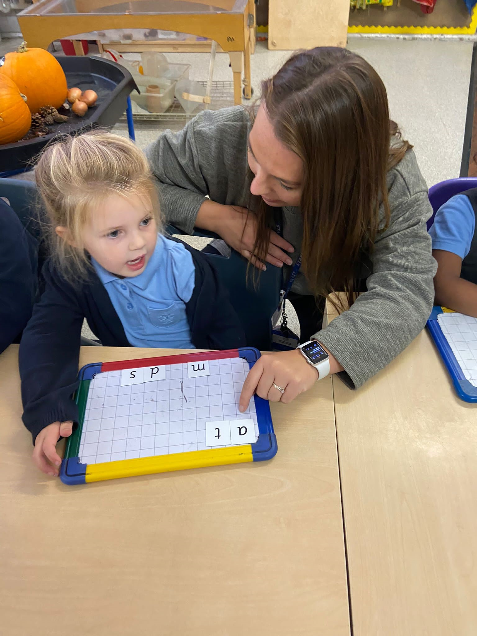 Adult and child using a whiteboard for learning